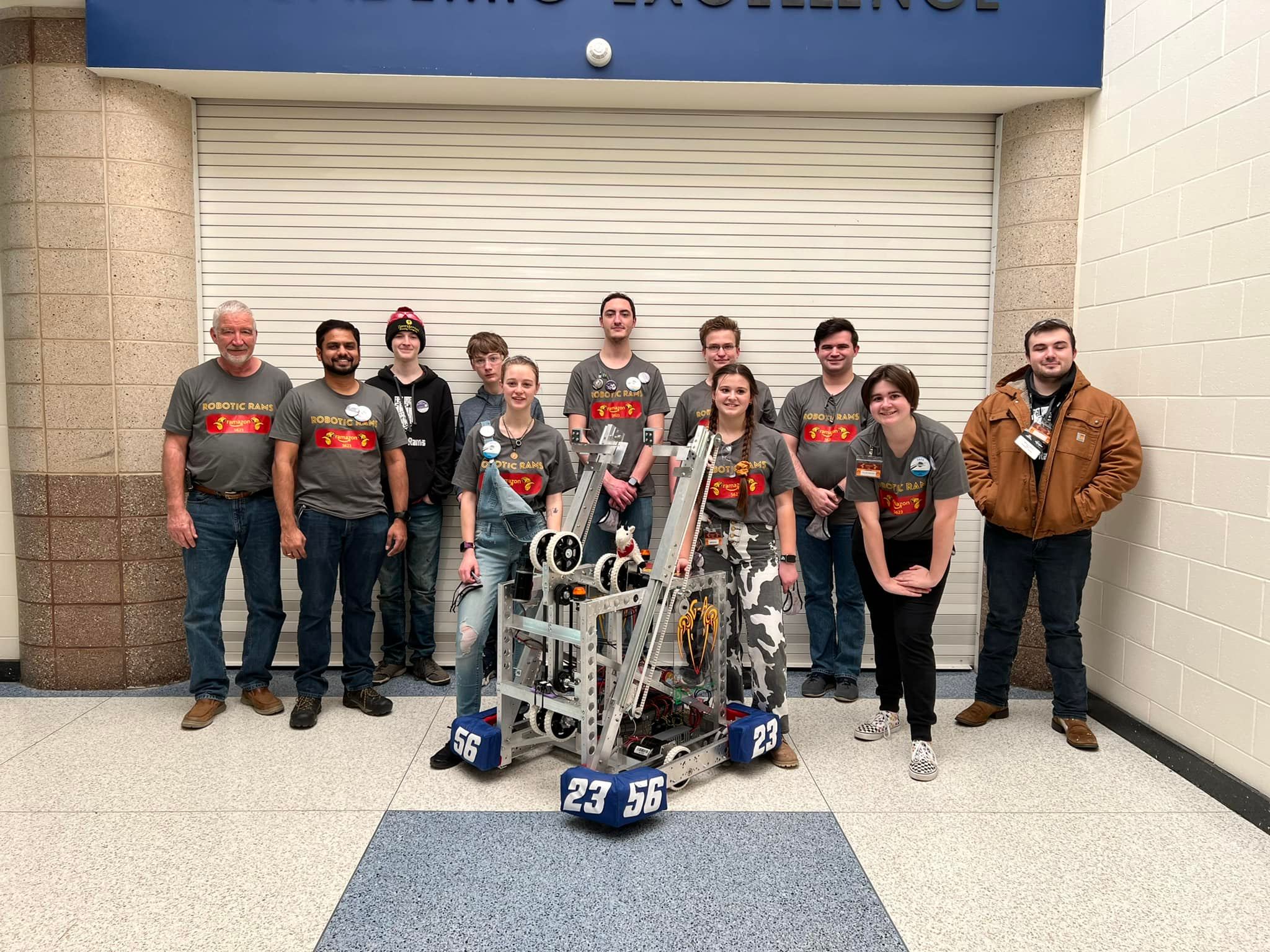 The robotics team posing with their 2021-2022 robot