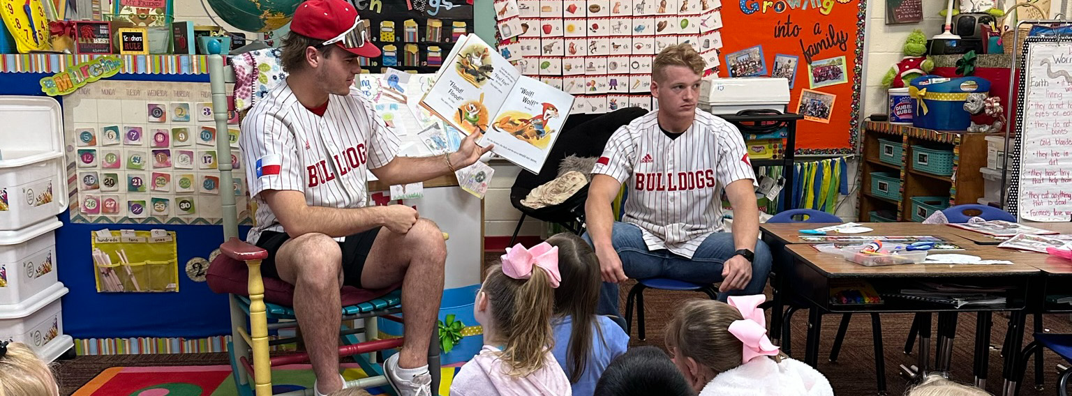 Brooks Brewster and Todd Register reading to a first grade class