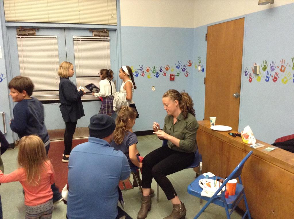 Teacher painting a students face