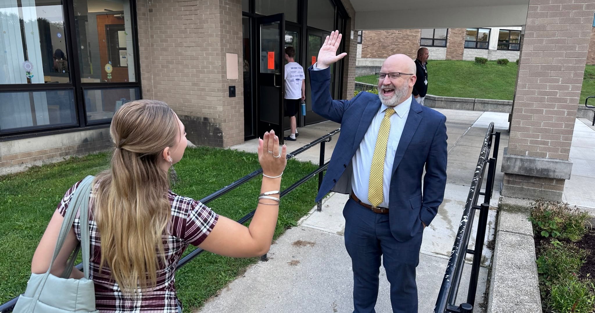 Superintendent High-Fiving Student Entering Drury