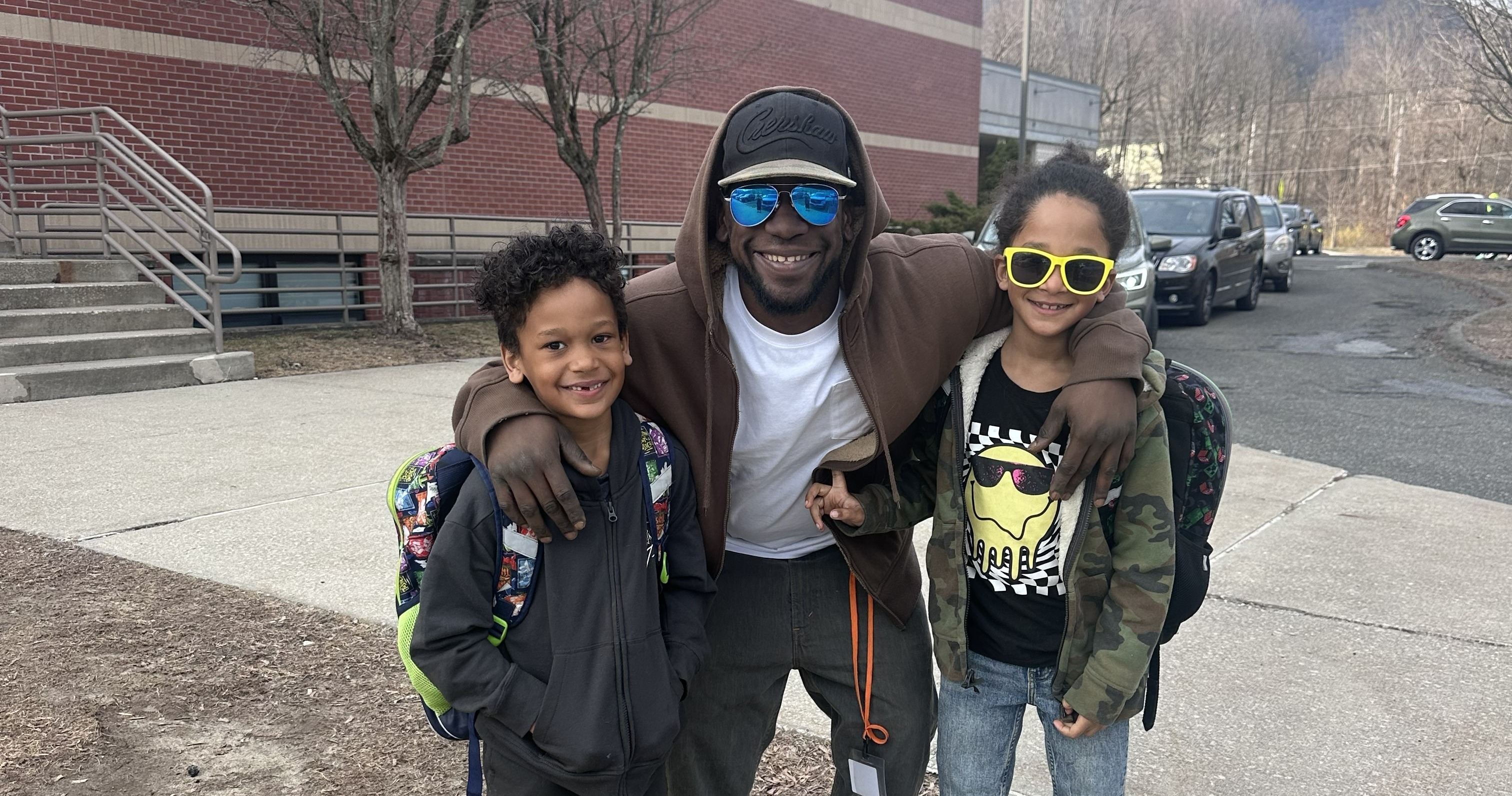 BES family posing together outside of the building.