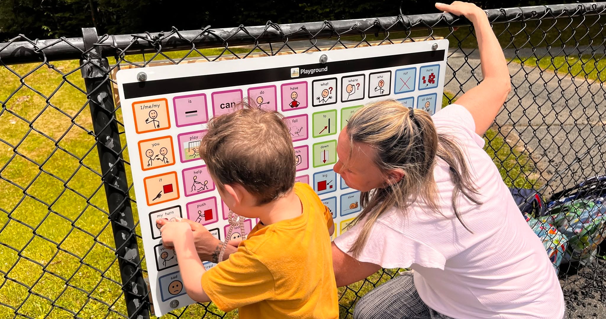 Student using chart to communicate on the playground