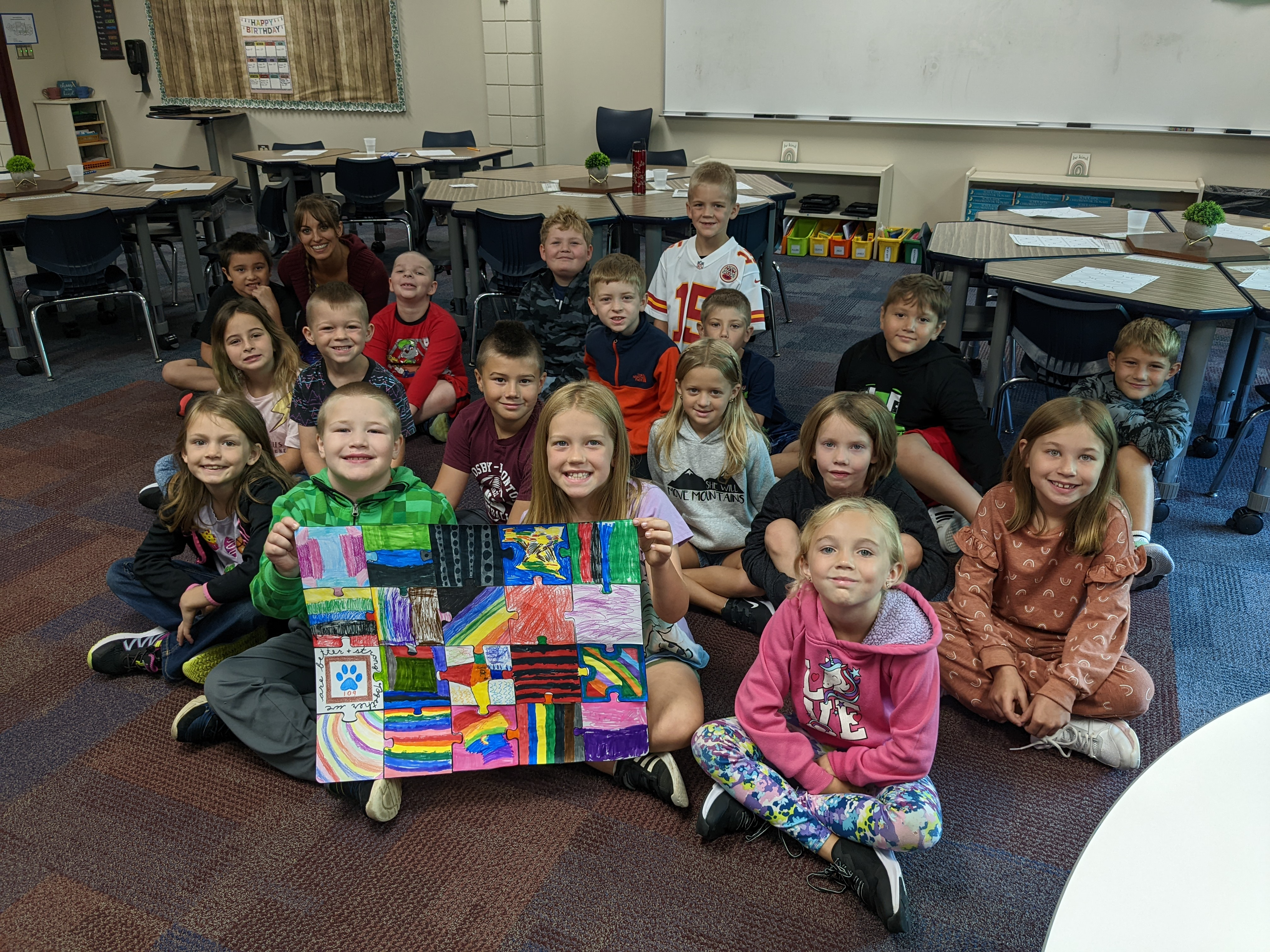 students holding a patchwork coloring 