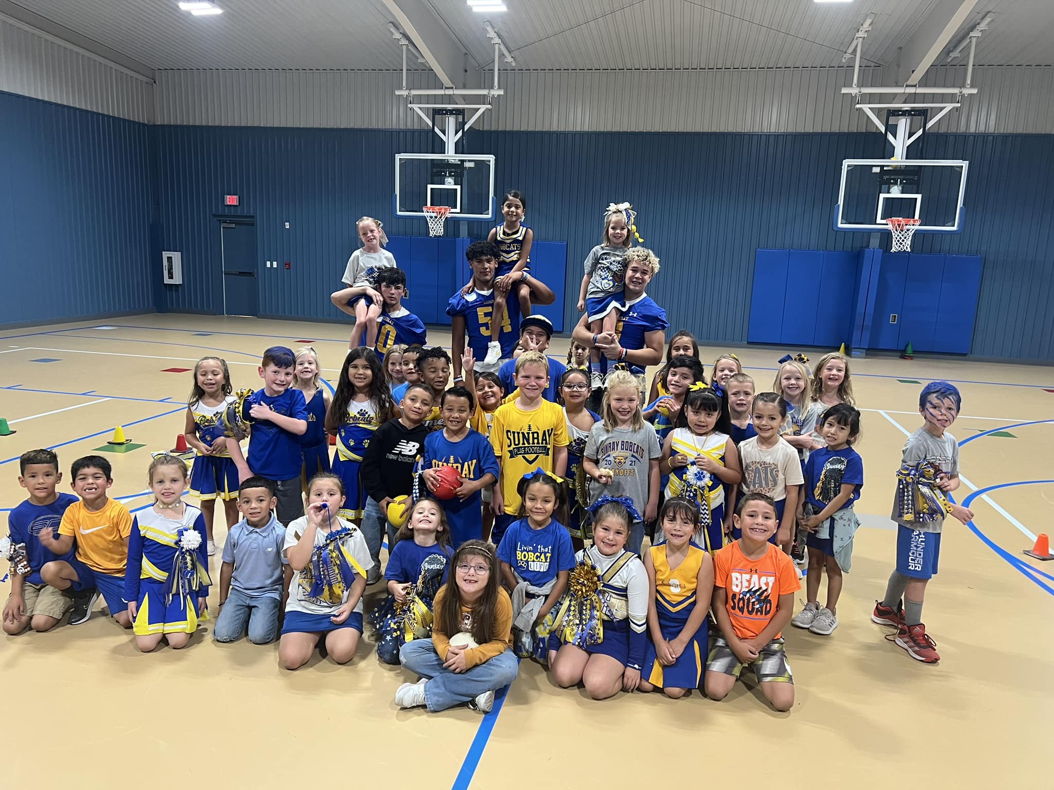 1st graders playing dodge ball with varsity players