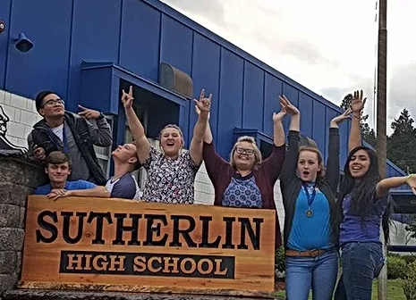 Students with the Sutherlin High School sign.