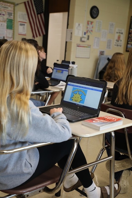 Student typing on laptop