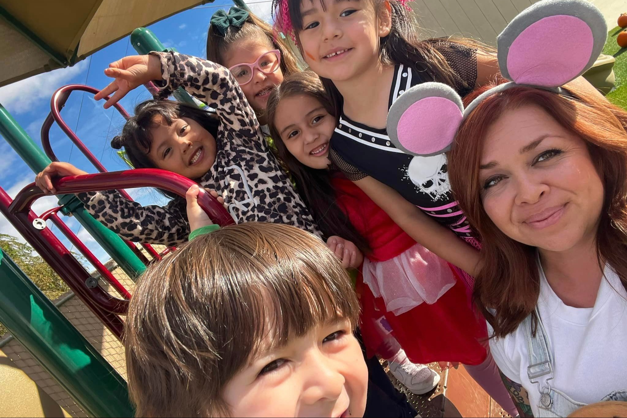 Preschool students with staff in playground
