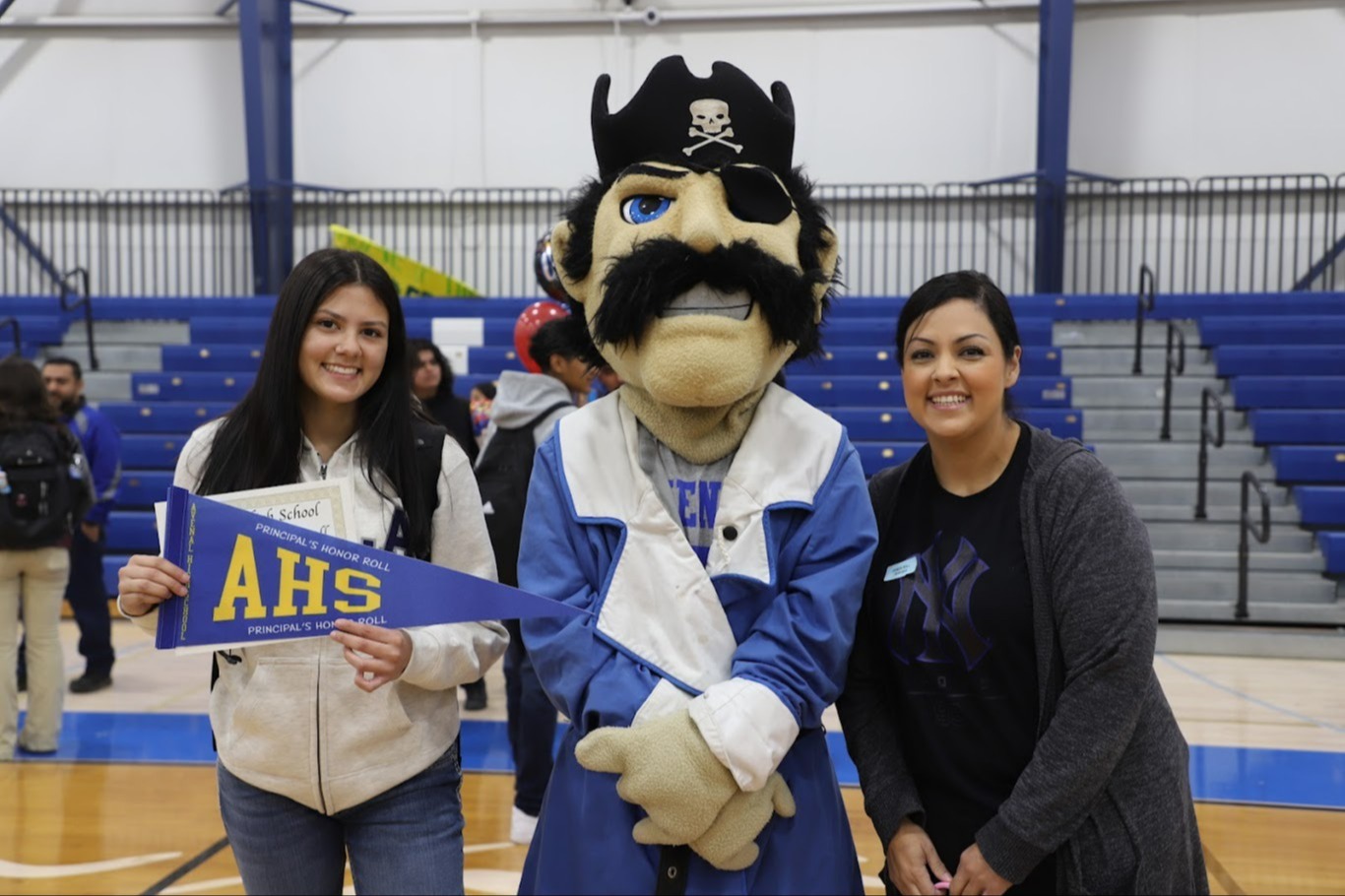 ahs mascot with student and parent award ceremony