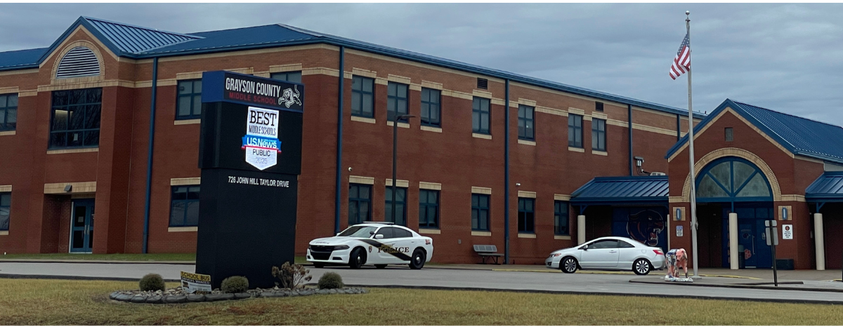 front of GCMS with digital sign and two cars in front