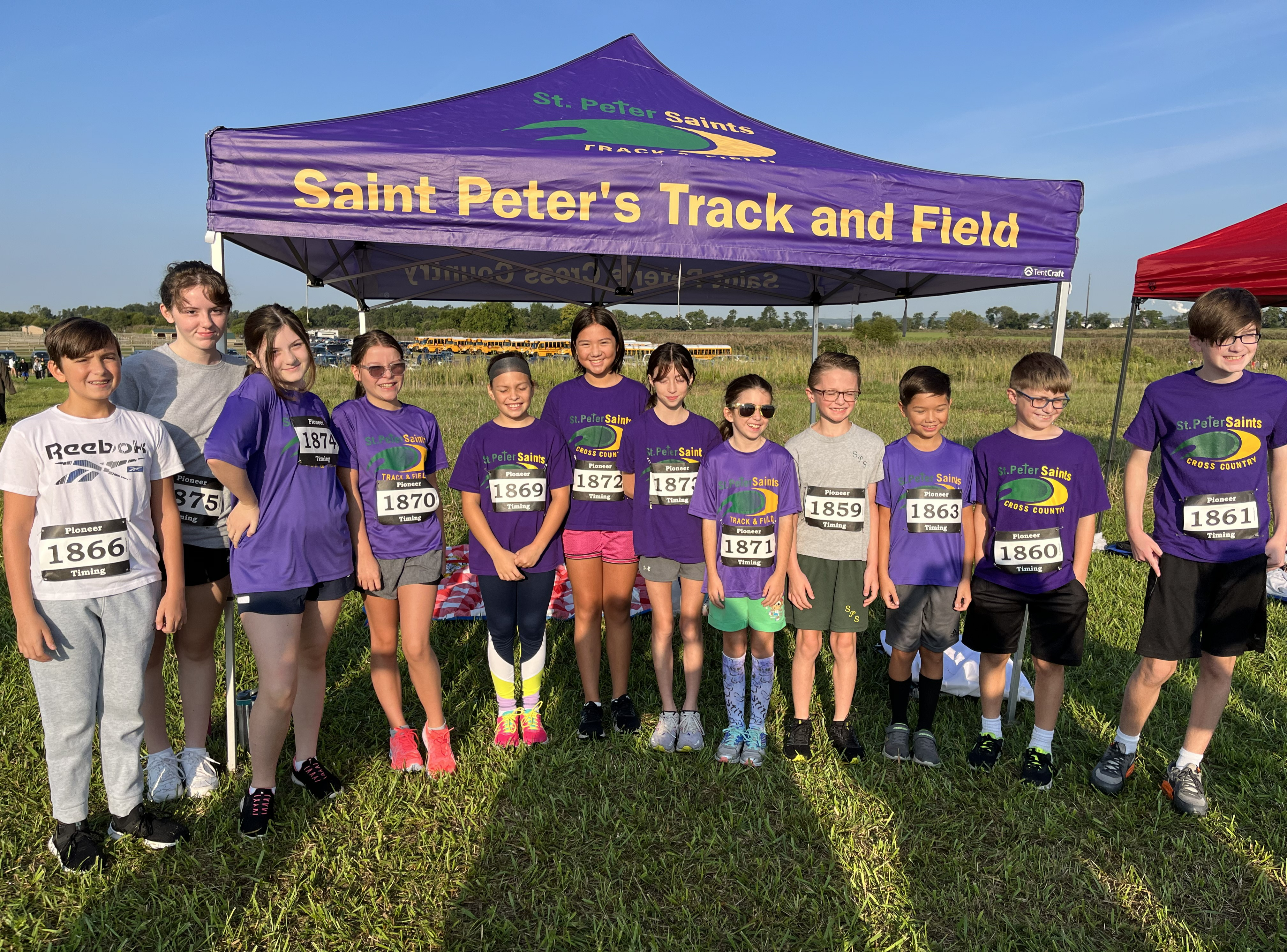 The St.  Peter School cross country team posing before beginning a race.