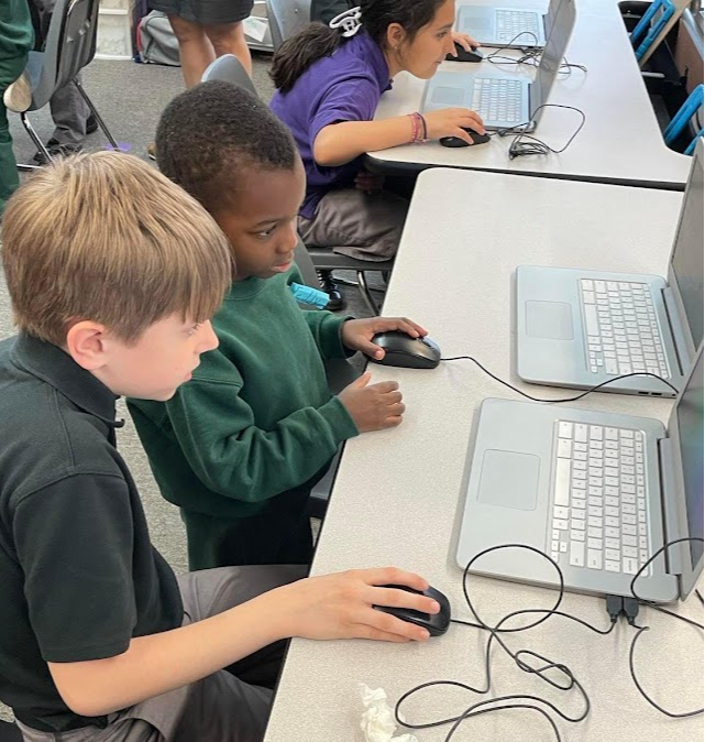 Fourth Grade teaching Pre-K 3 how to use a computer mouse