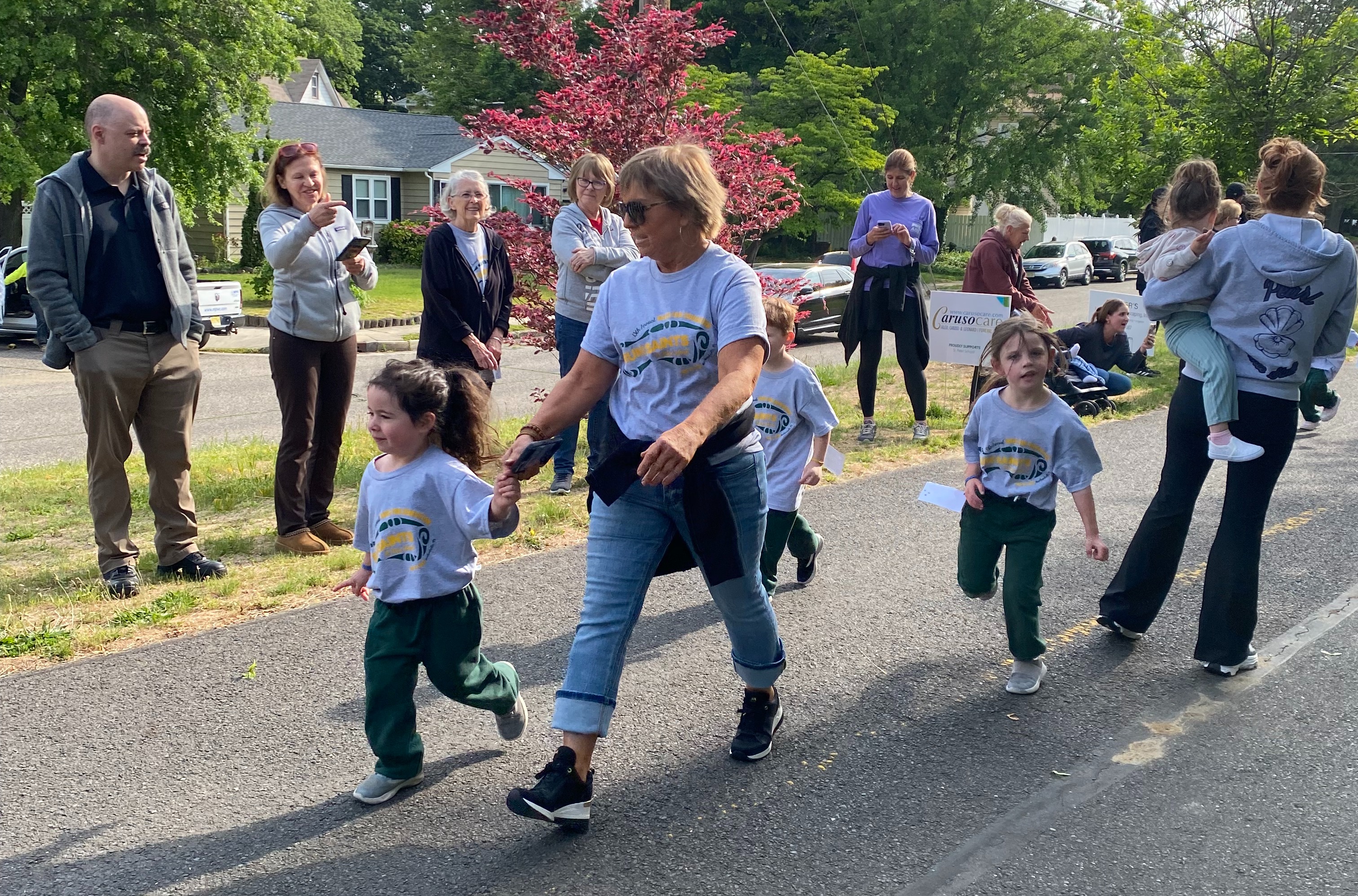 Pre-School students walking with their teacher at St. Peter School Race for Education
