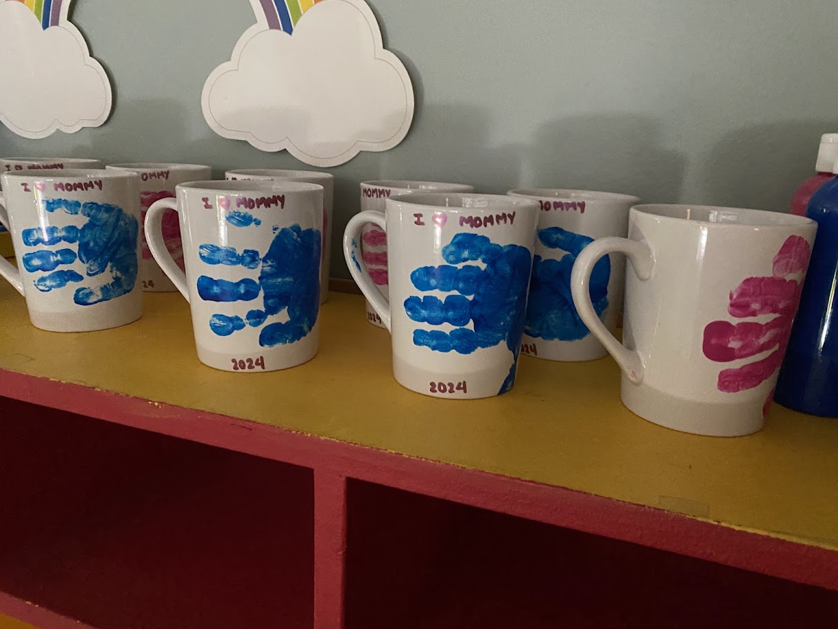 white ceramic mugs with pre-schooler handprints on them
