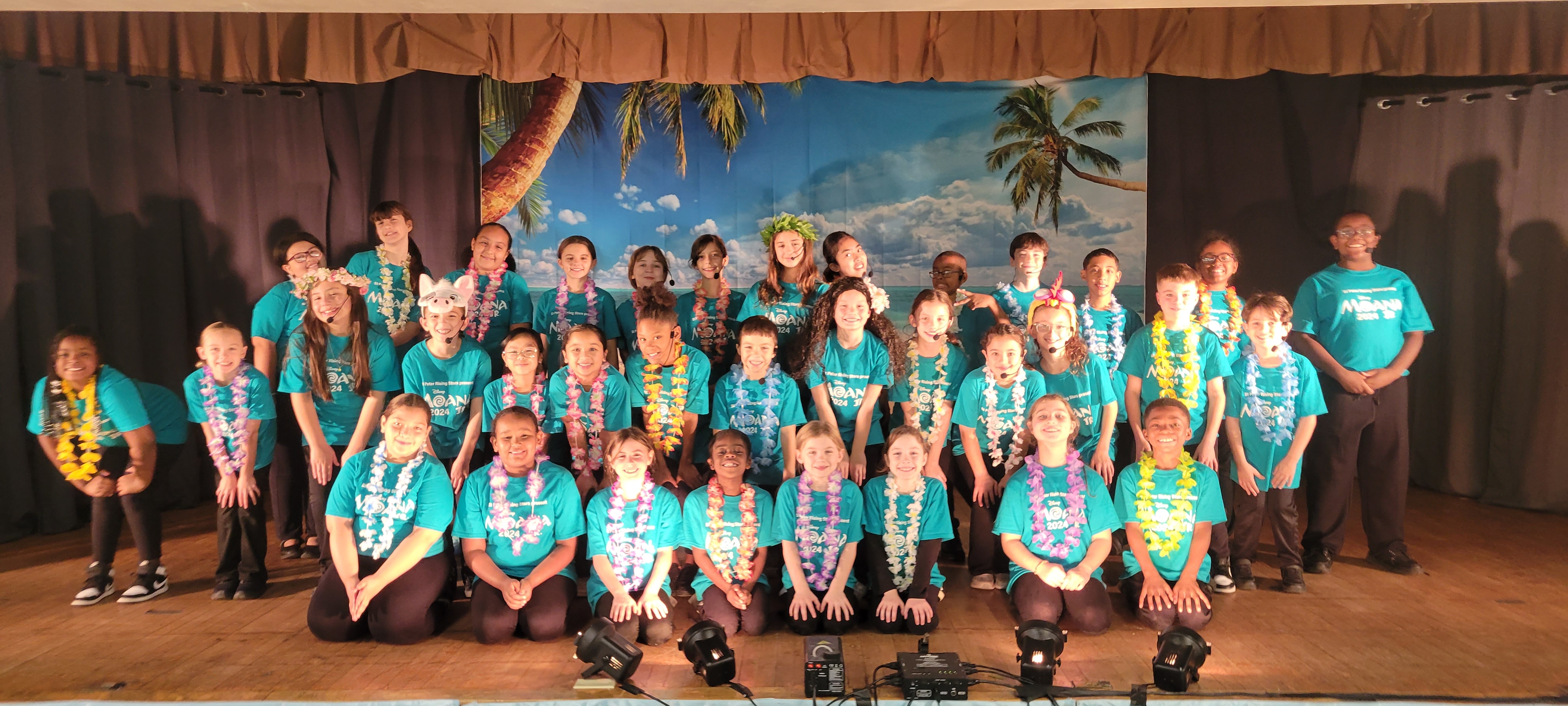 The cast of Moana, Jr, wearing teal t-shirts