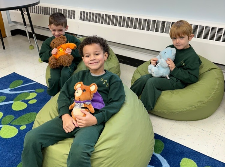 A group of pre-school boys sitting in beanbag chairs