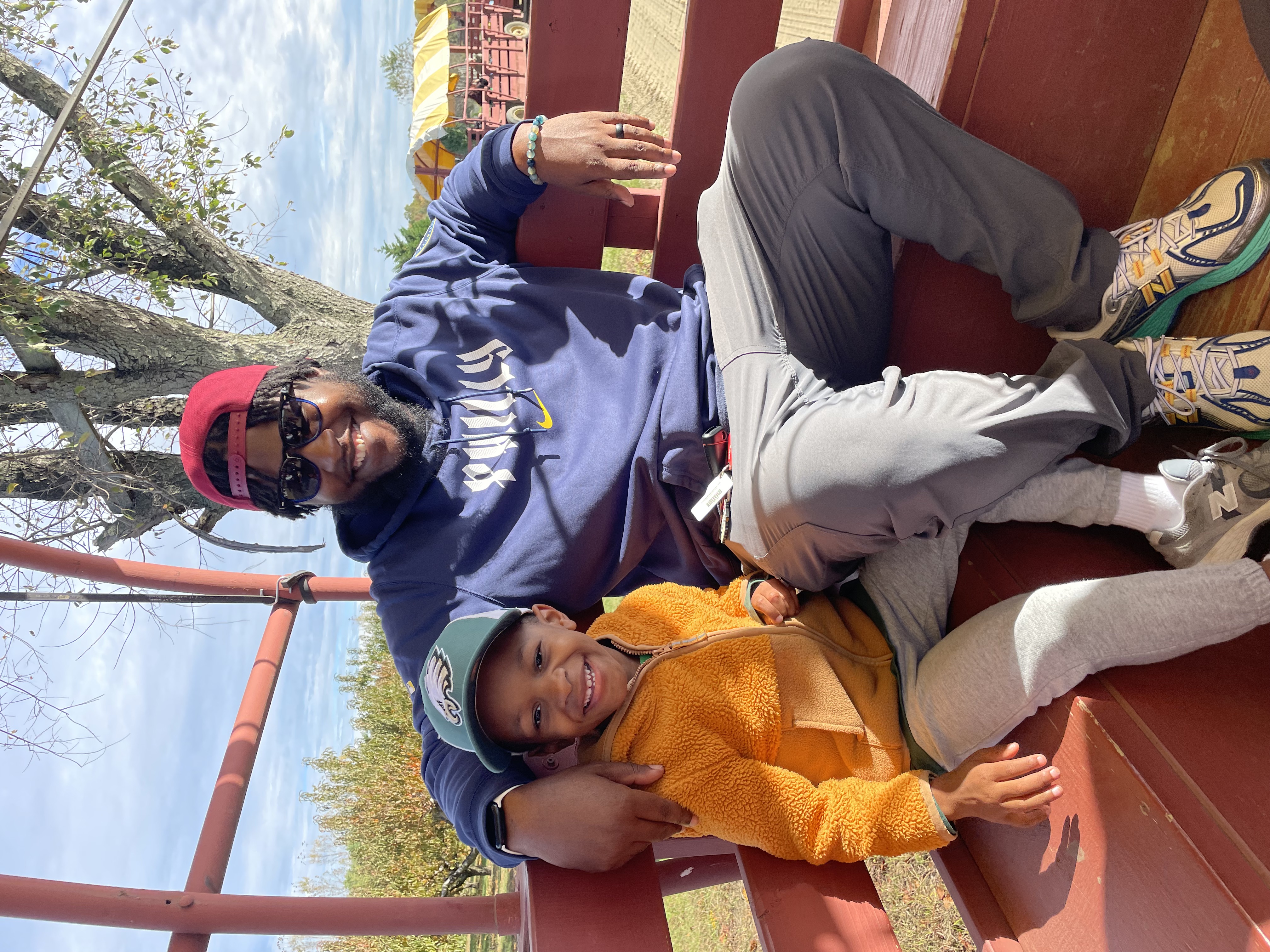 A father with his pre-school age son on a pumpkin picking trip