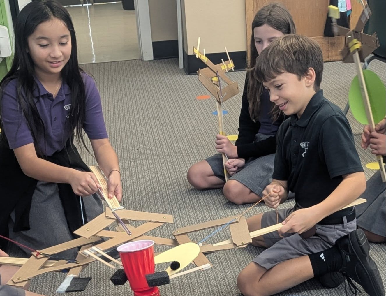 A group of 4th grade St. Peter Students creating "grabbers" out of found materials.