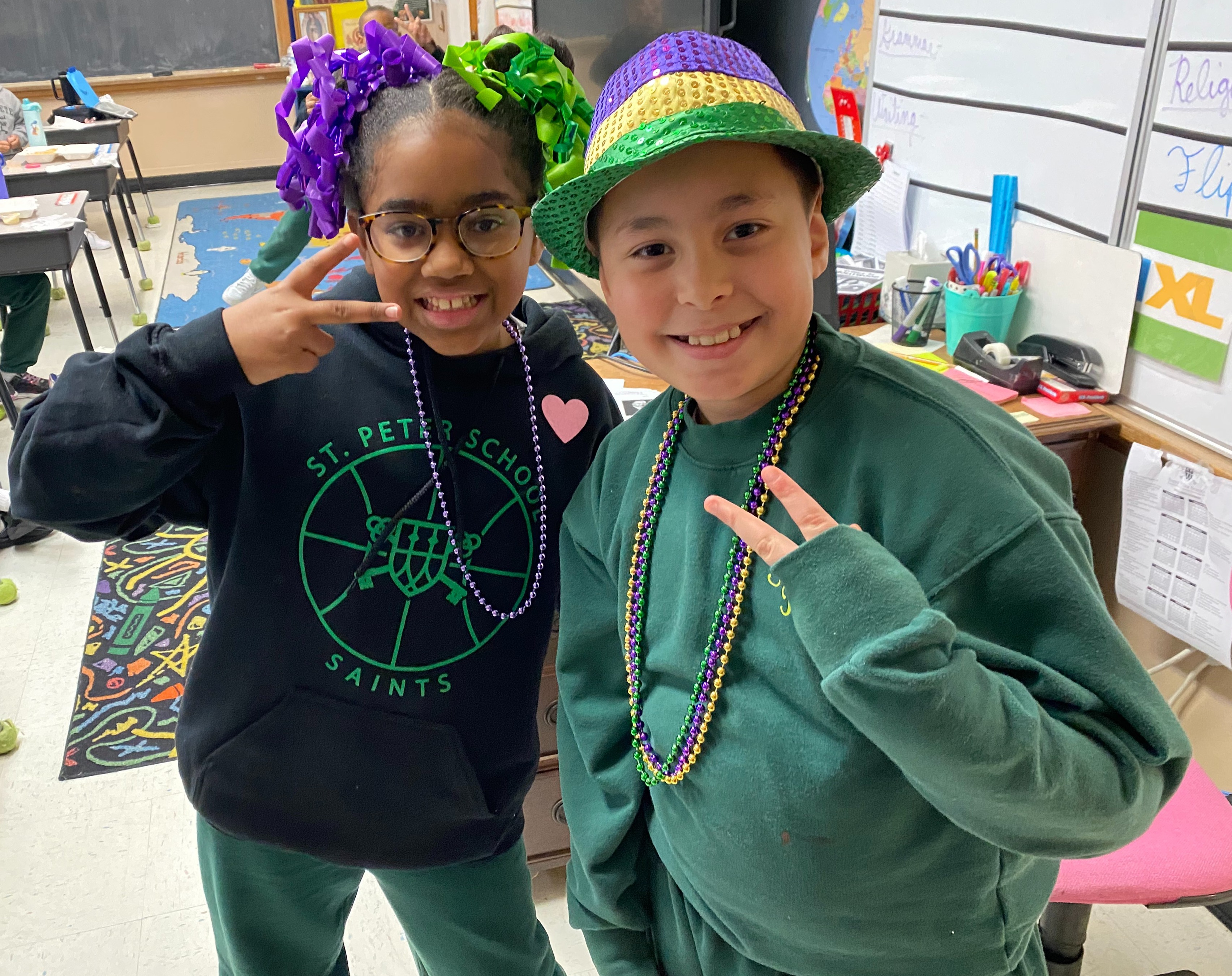 Two 4th grade students dressed in Purple, Green and Gold for Spirit Week