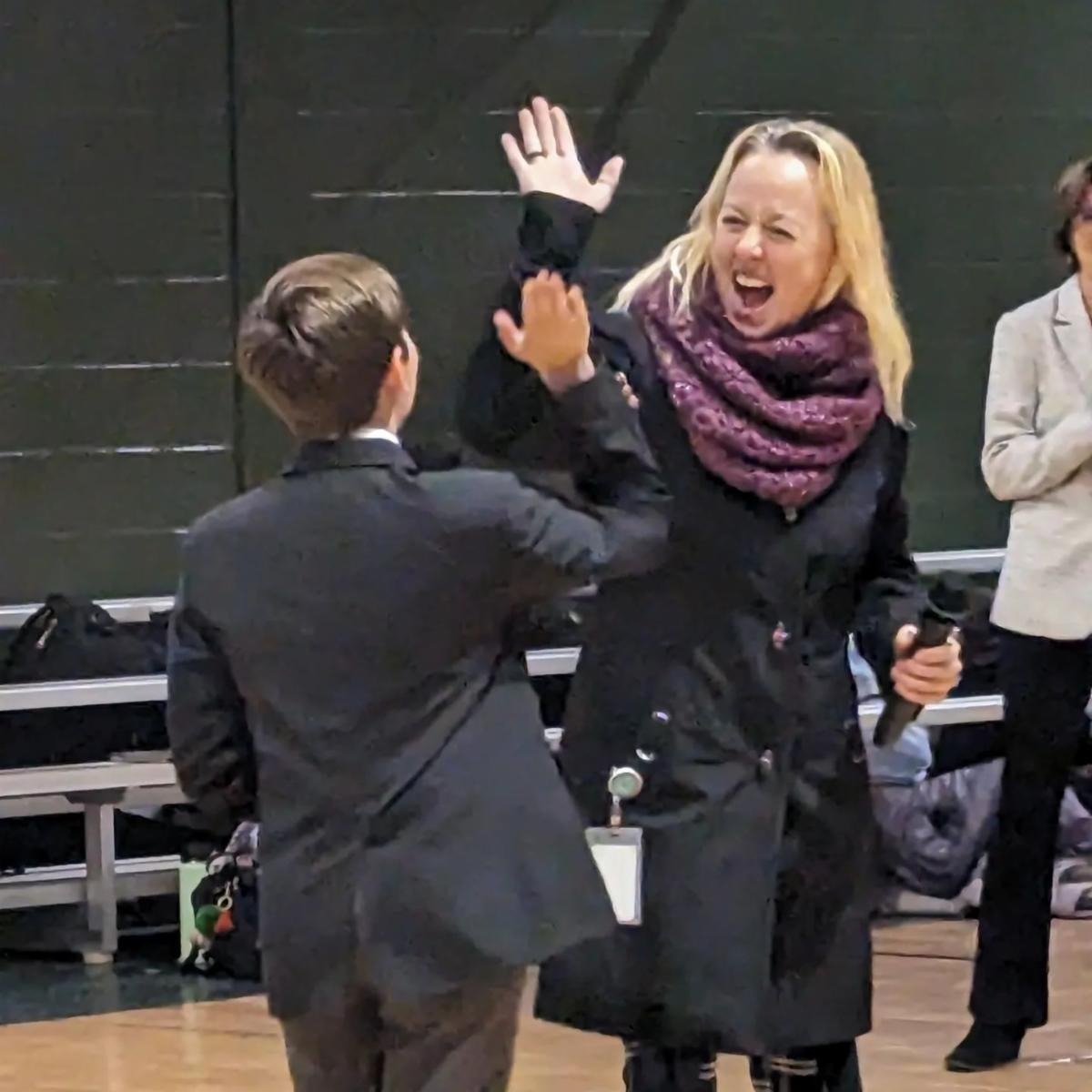 A student and a teacher high-fiving