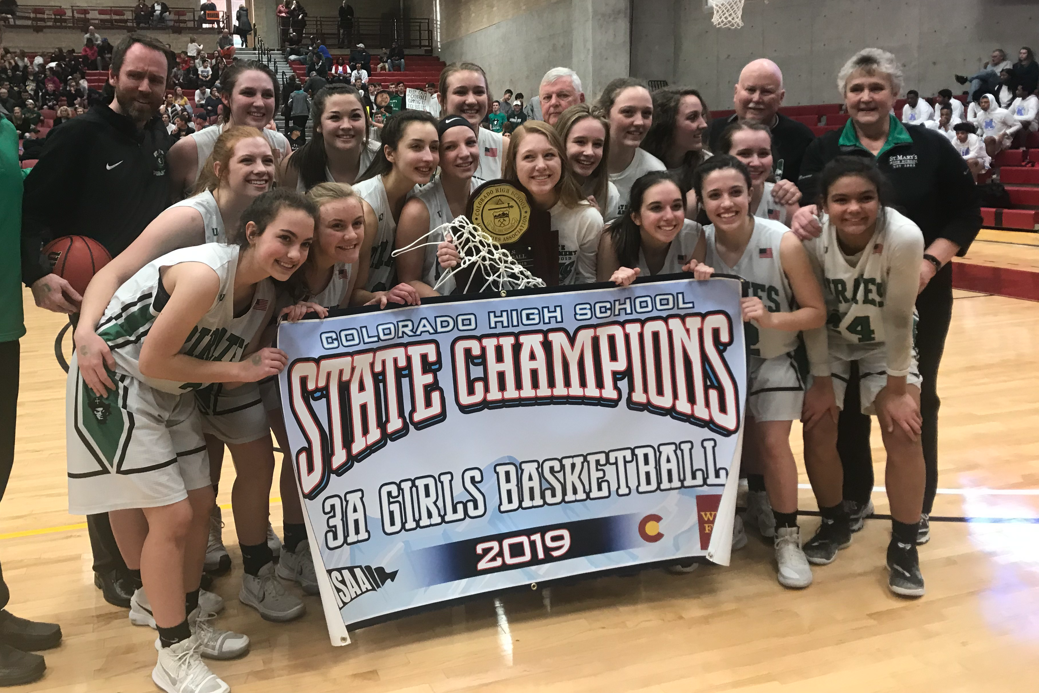 Girls basketball team with trophy