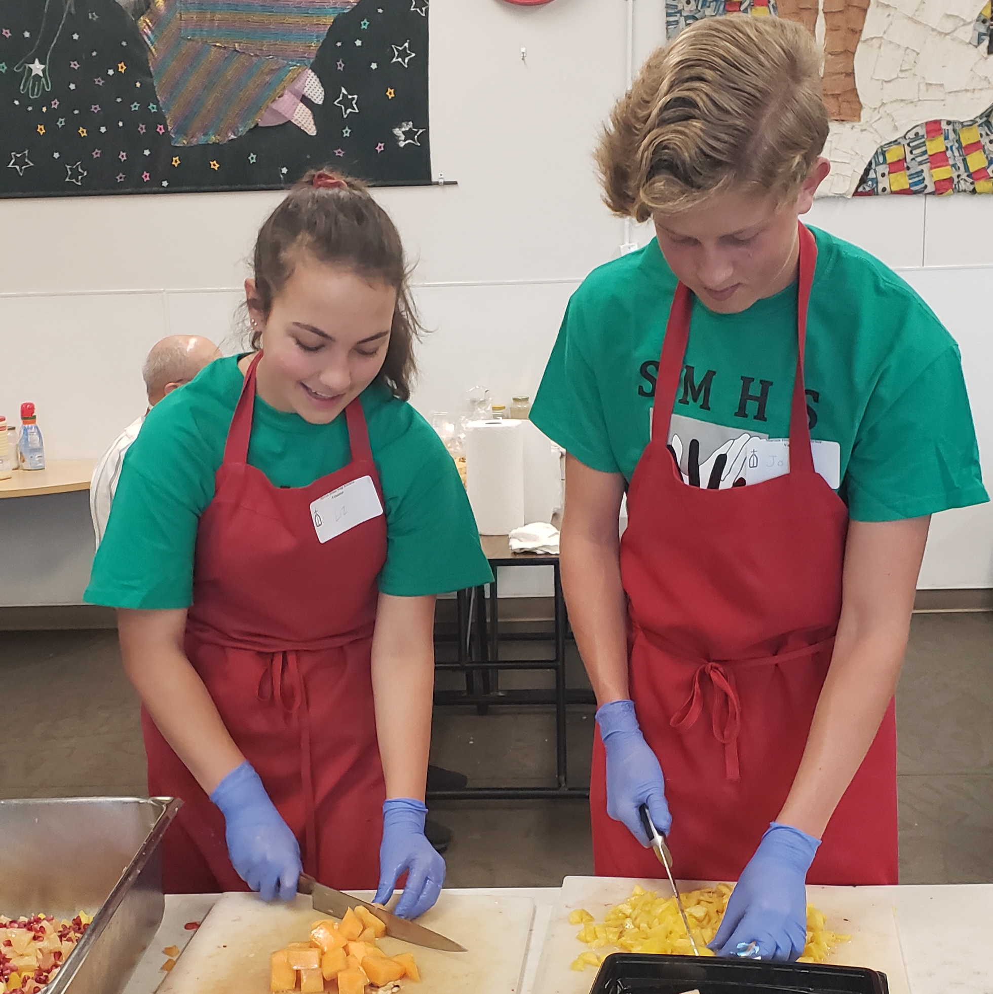 2 students cutting up food
