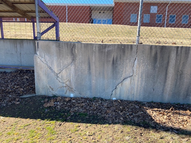 crumbling wall of softball field