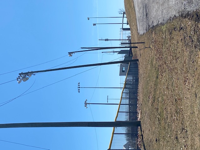 leaning lights on softball field and powerlines