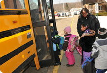 students getting on a bus