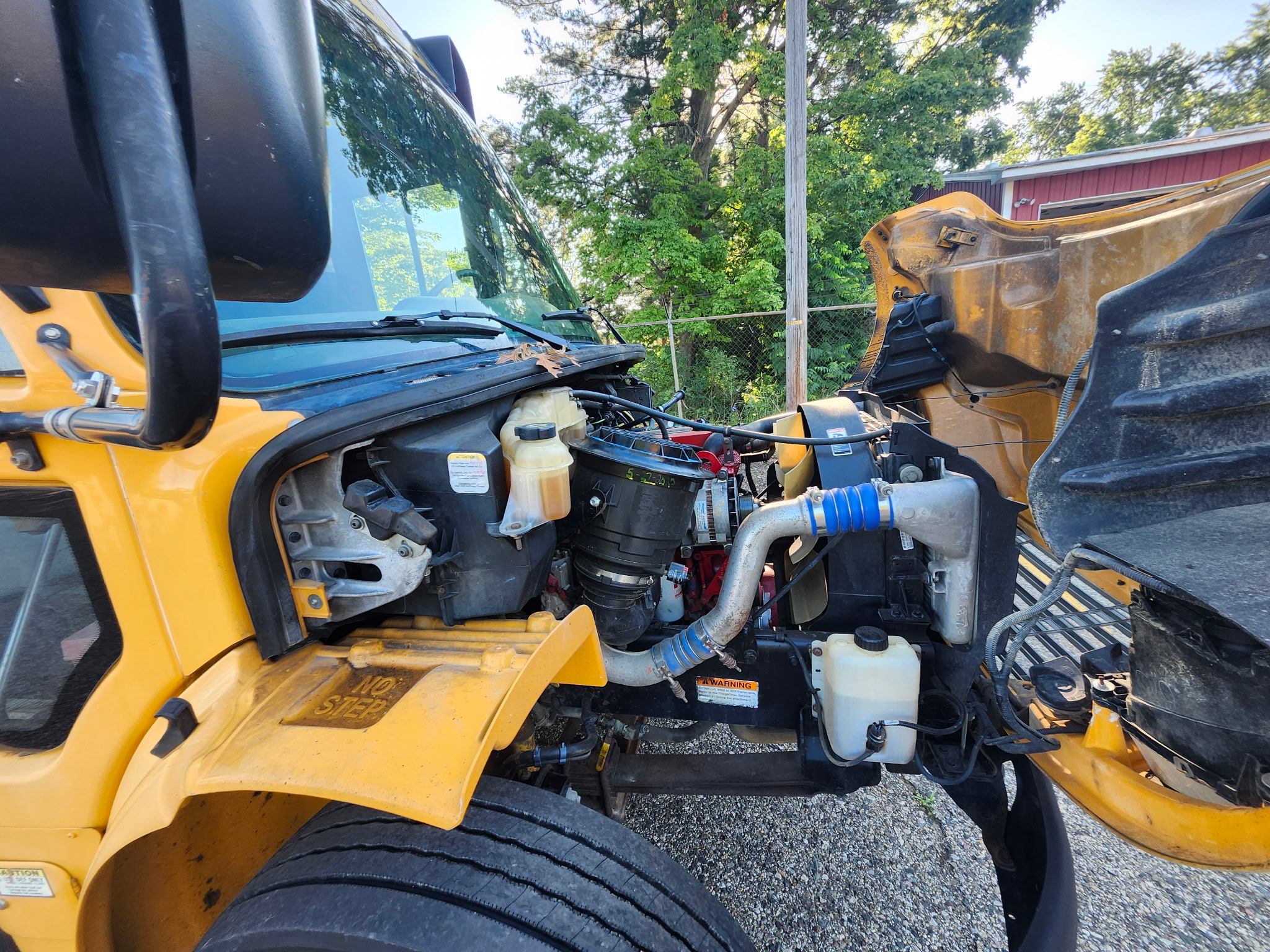 passenger side of school bus engine