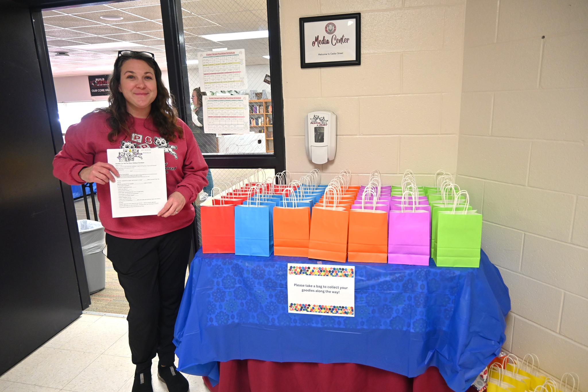 Teacher standing next to a table full of gift bags