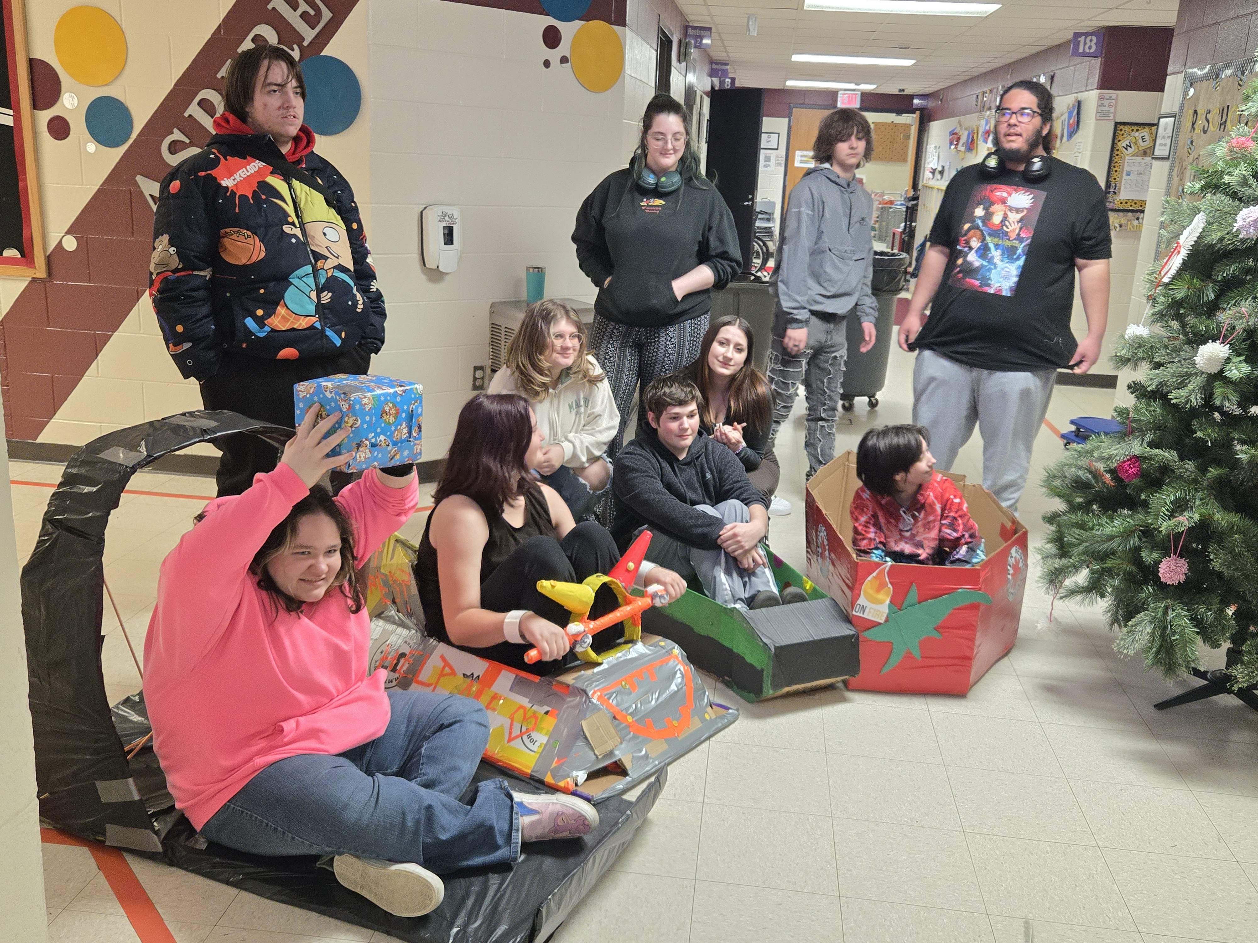 Students pose for group photo during Winter Holiday celebrations with their sled creations.