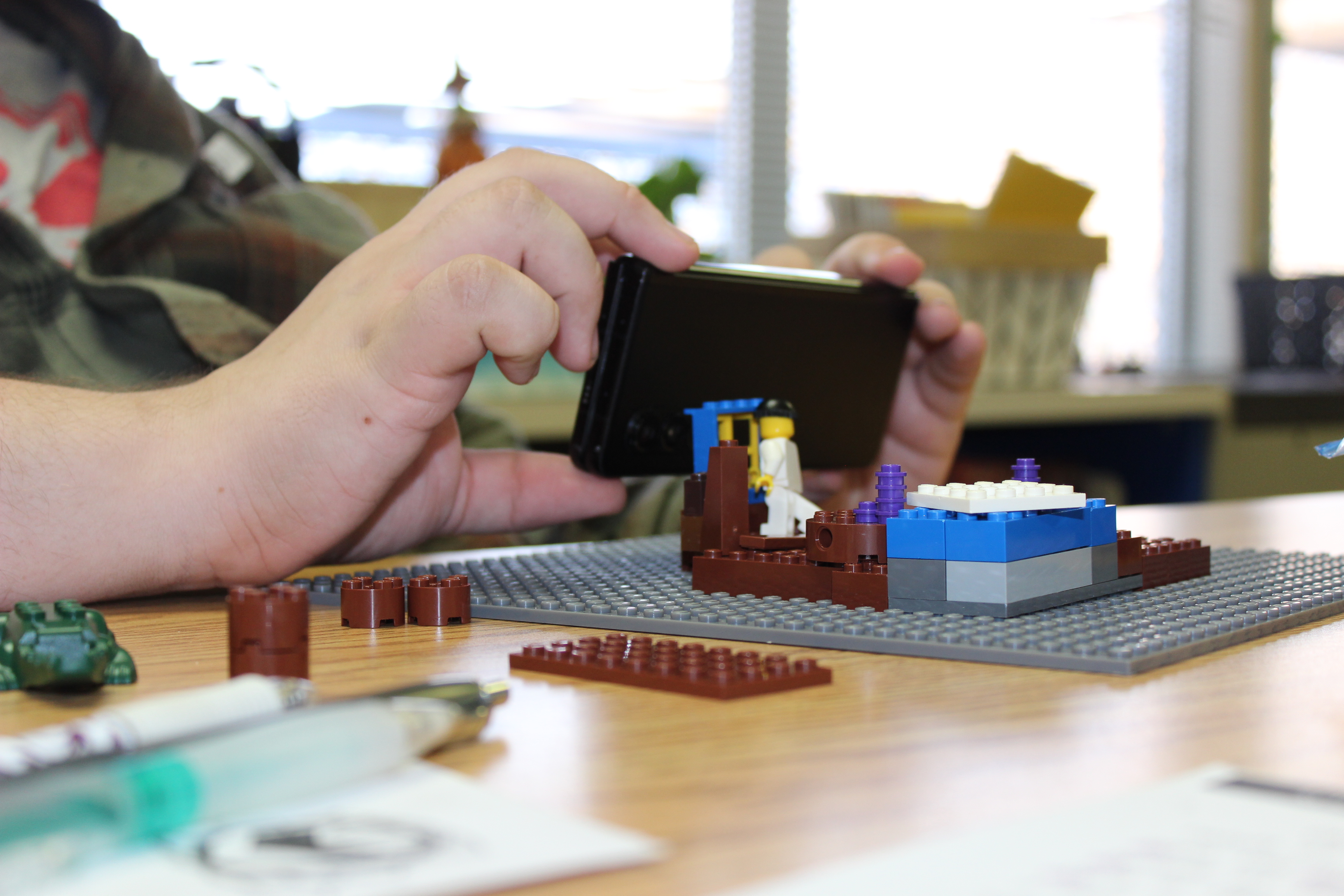 student recreating a set from a play using Legos
