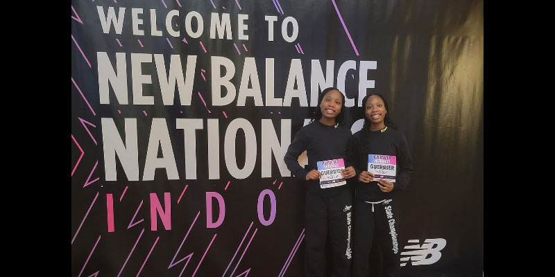 High School track stars Victoria Guerrier and Gloria Guerrier smiling in front of giant banner that reads "Welcome to New Balance Nation."