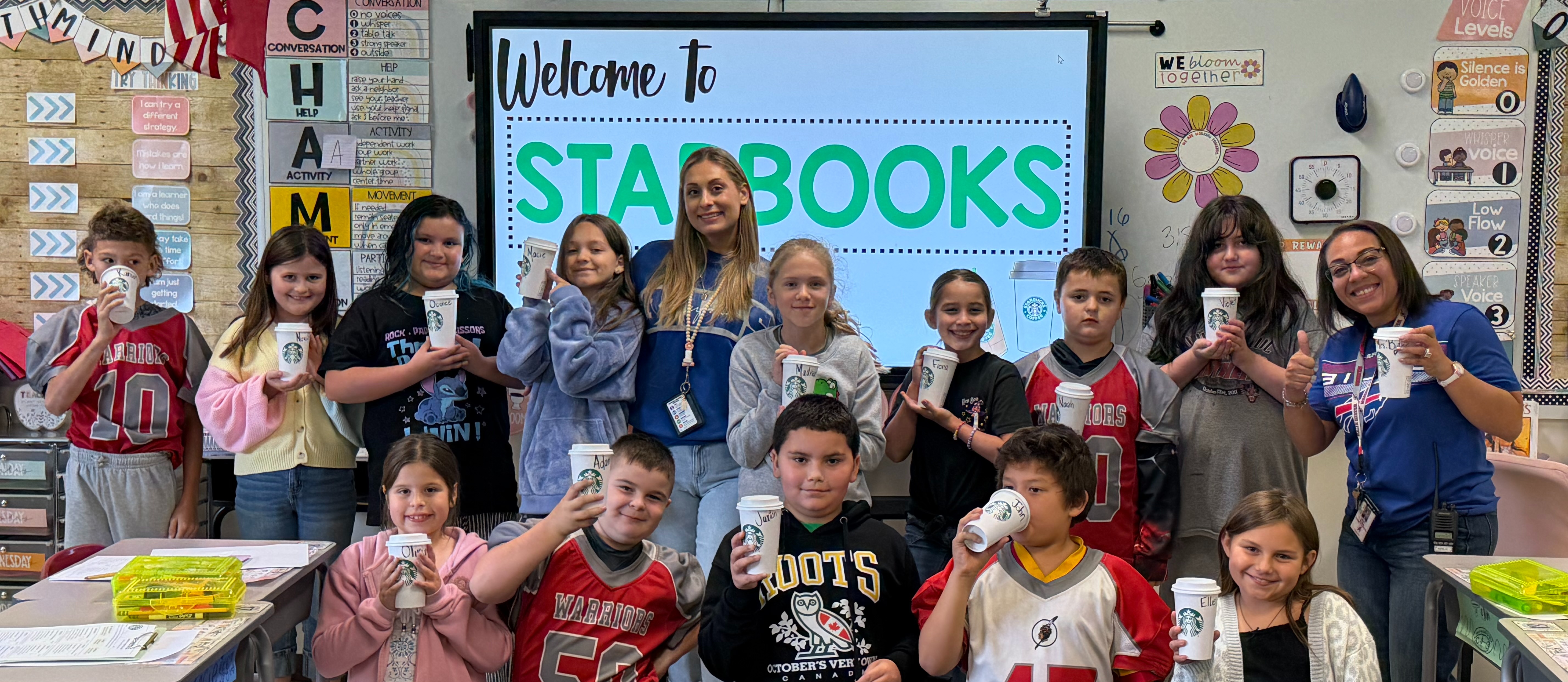 4th Grade Class showing off their project with a teacher