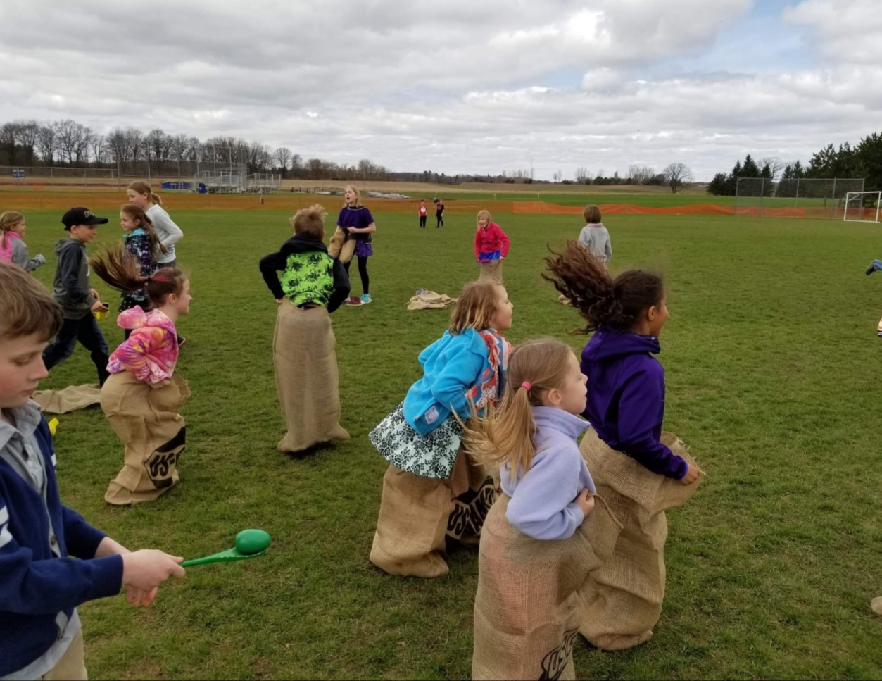 A photo of the students playing in the field.