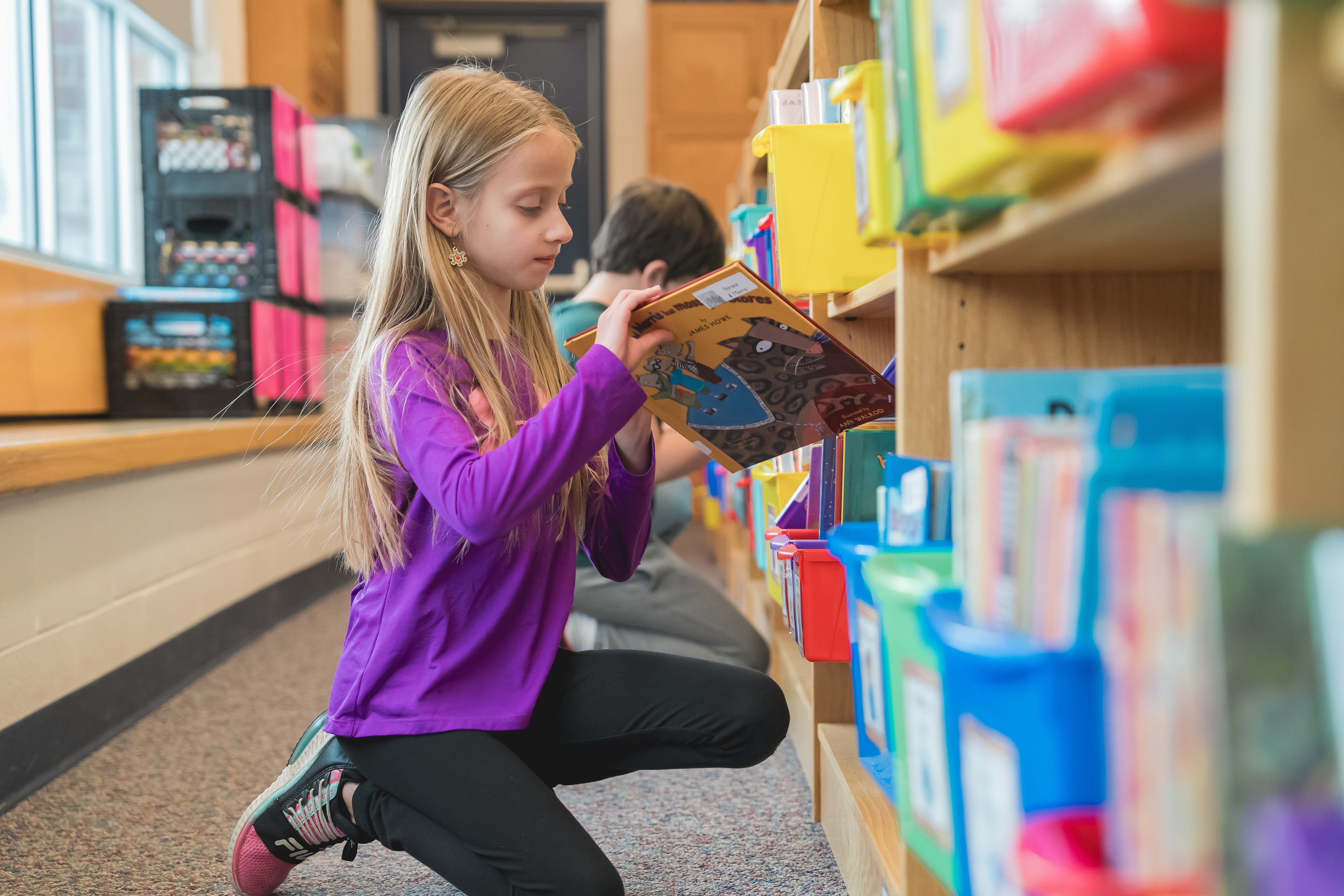 RCAPS Student choosing a book