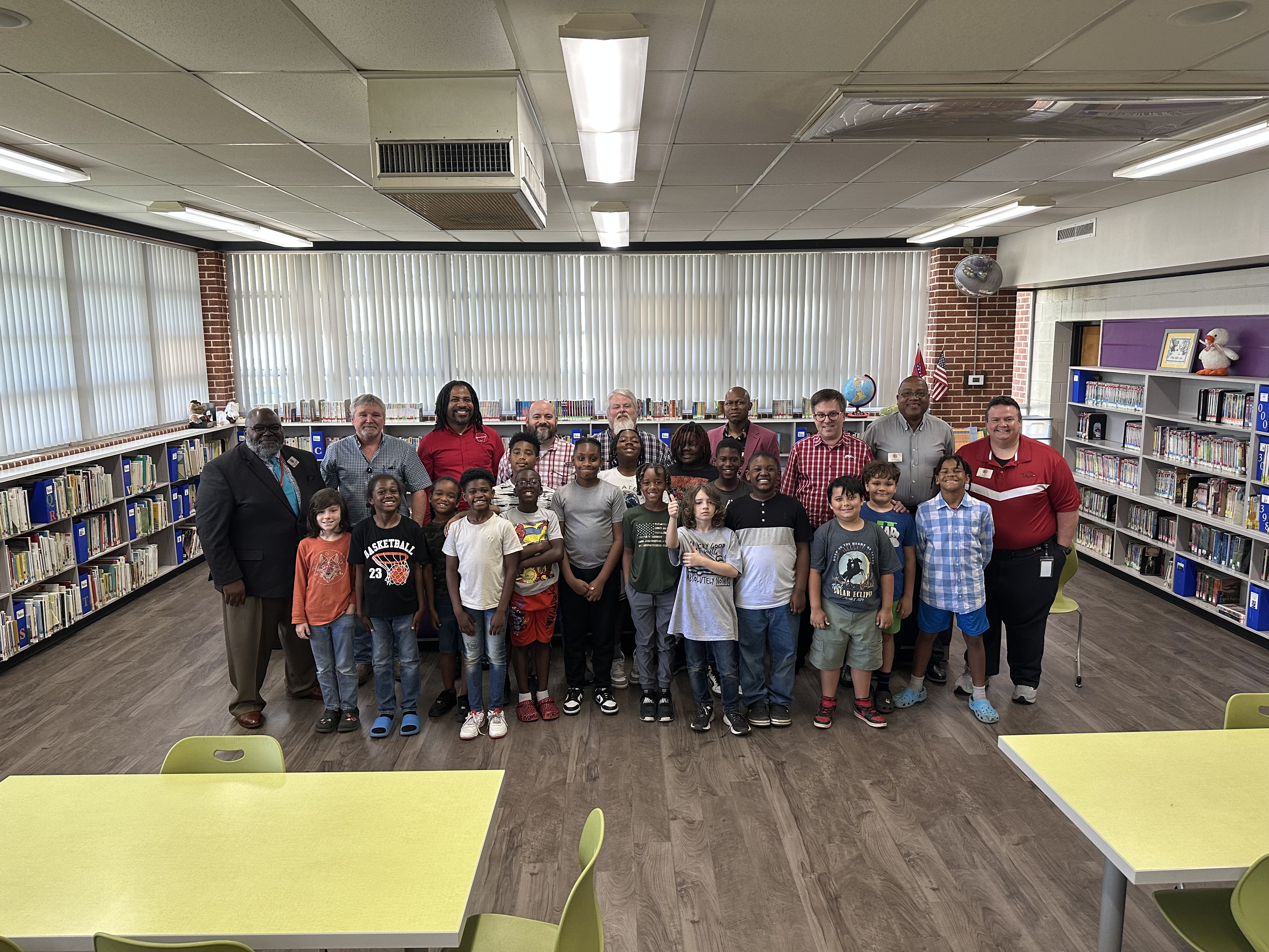 A photo of children and volunteers