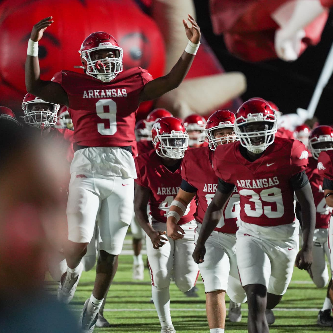 Football players running into the stadium for a game