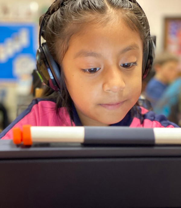 A girl learning through the use of a tablet