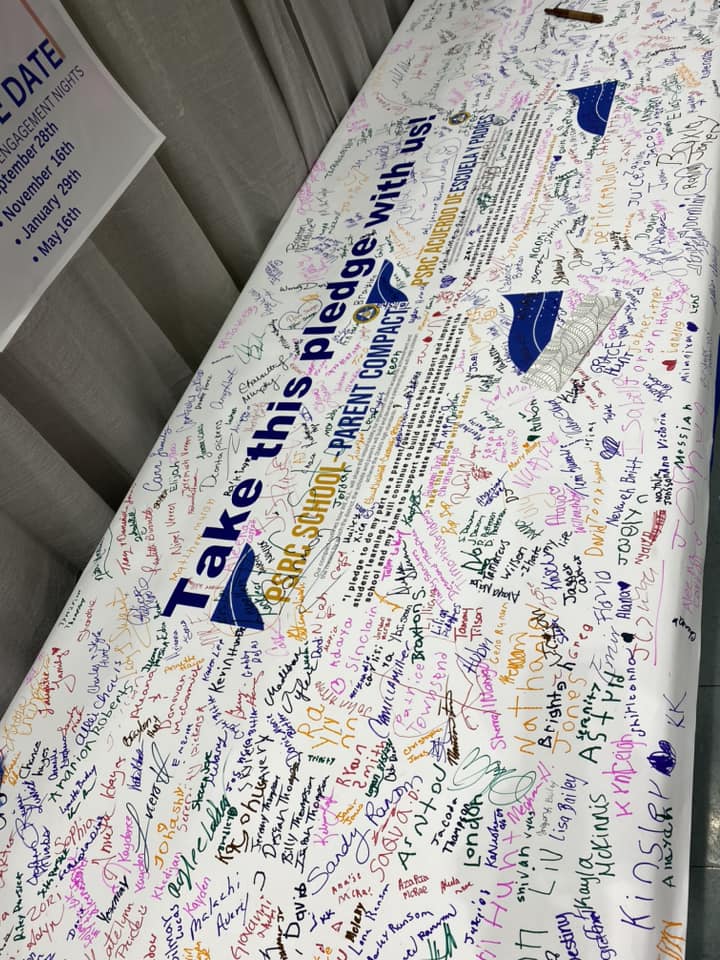 Picture of School-Parent Banner Being Signed 