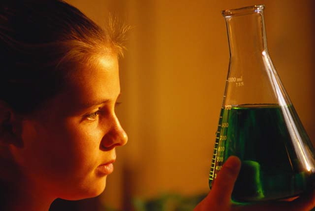 Photo of a girl with a lab glass.