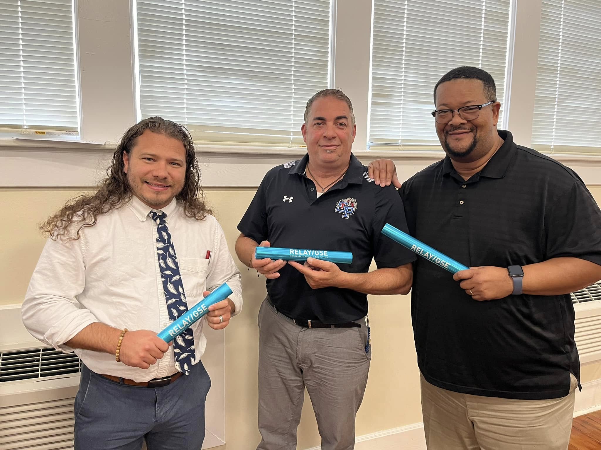 St Pauls High School assistant principals pose with Relay GSE batons earned for completing program