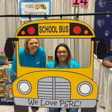 Amanda and Candice pose with bus prop