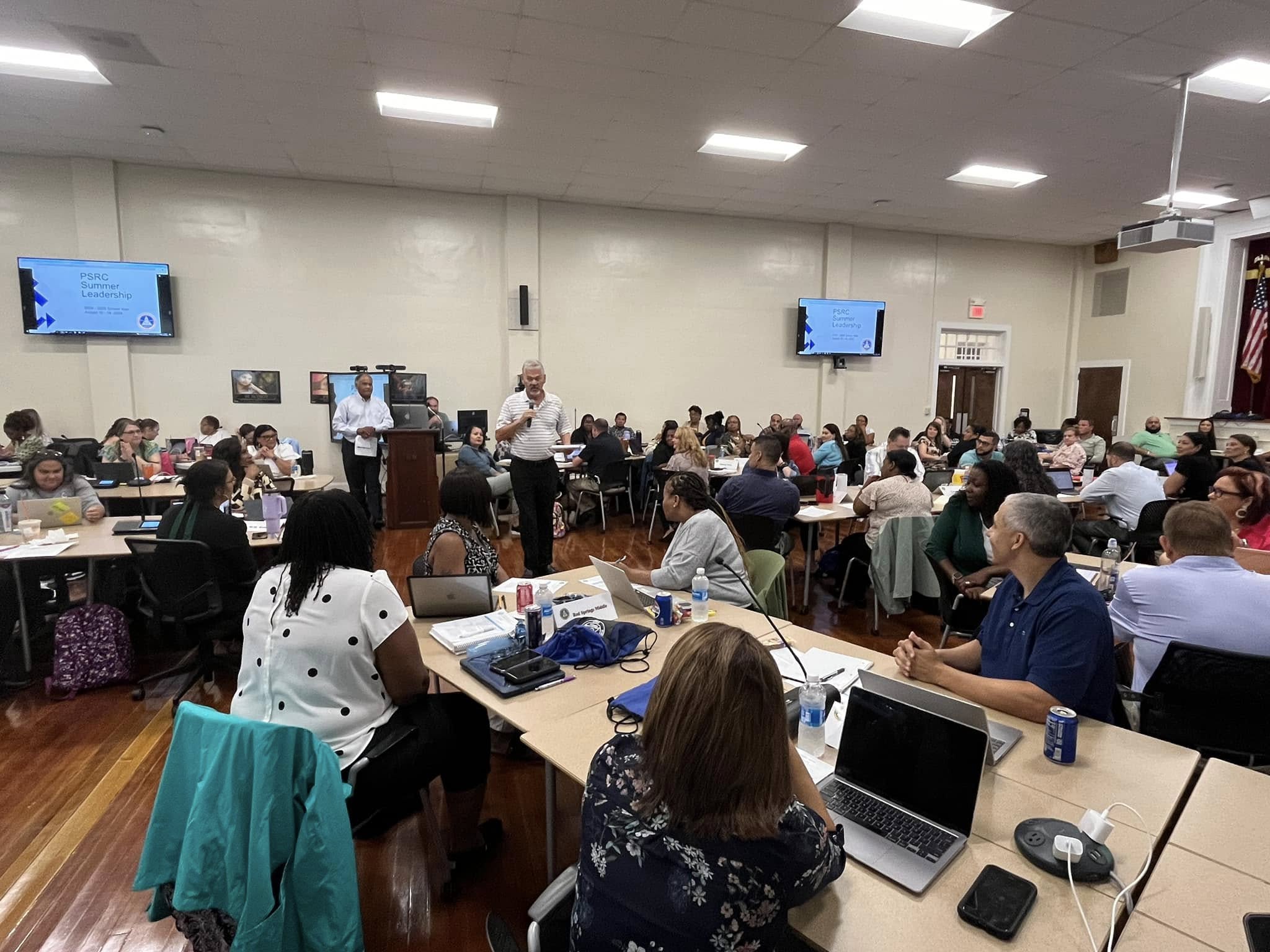 summer leadership sessions with board member Mr. Craig Lowry speaking to principals