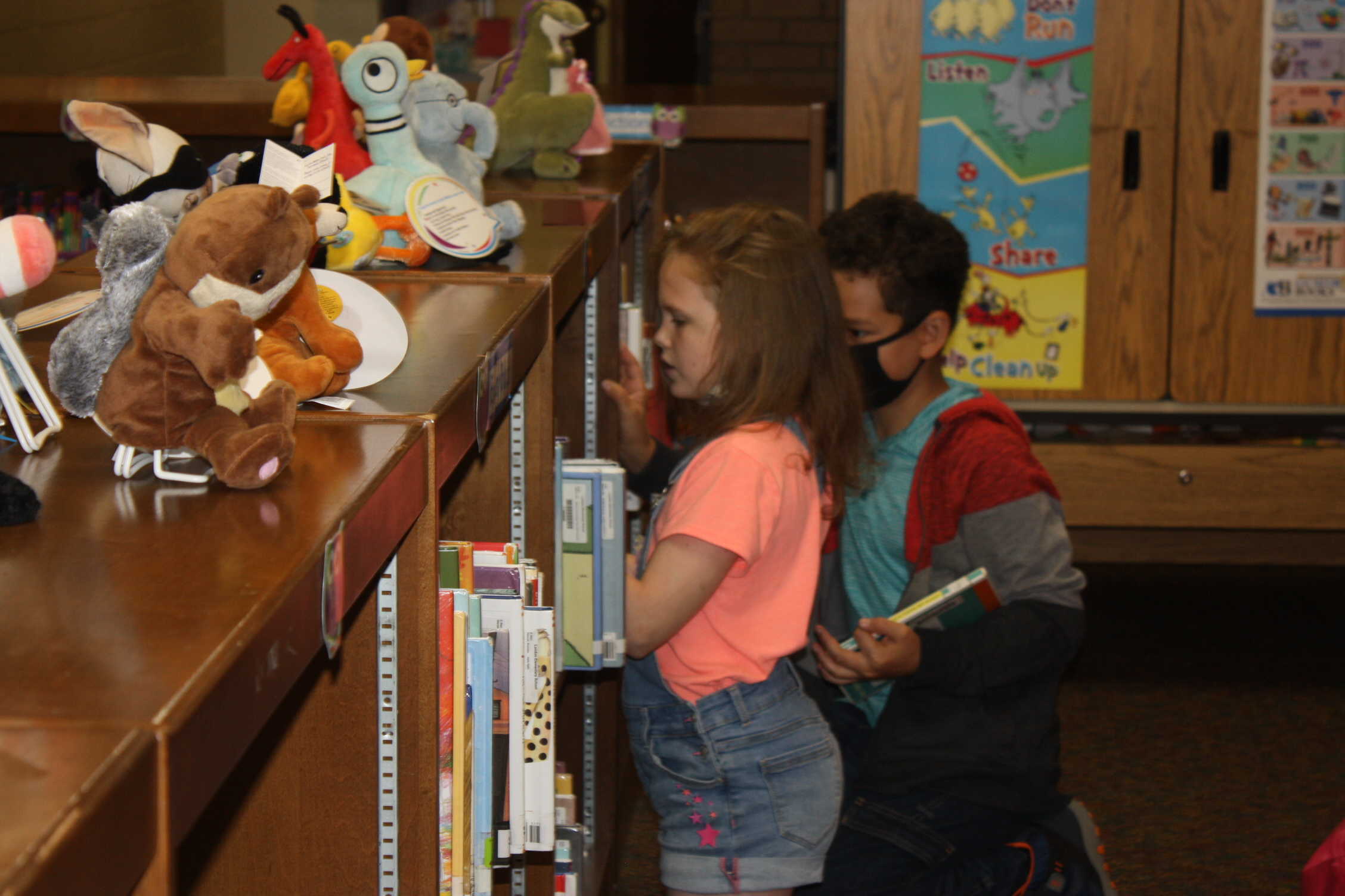 Students looking for books in the library.