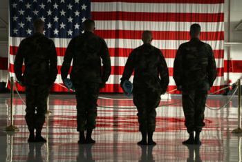 Soldier silhouettes in front of the American flag