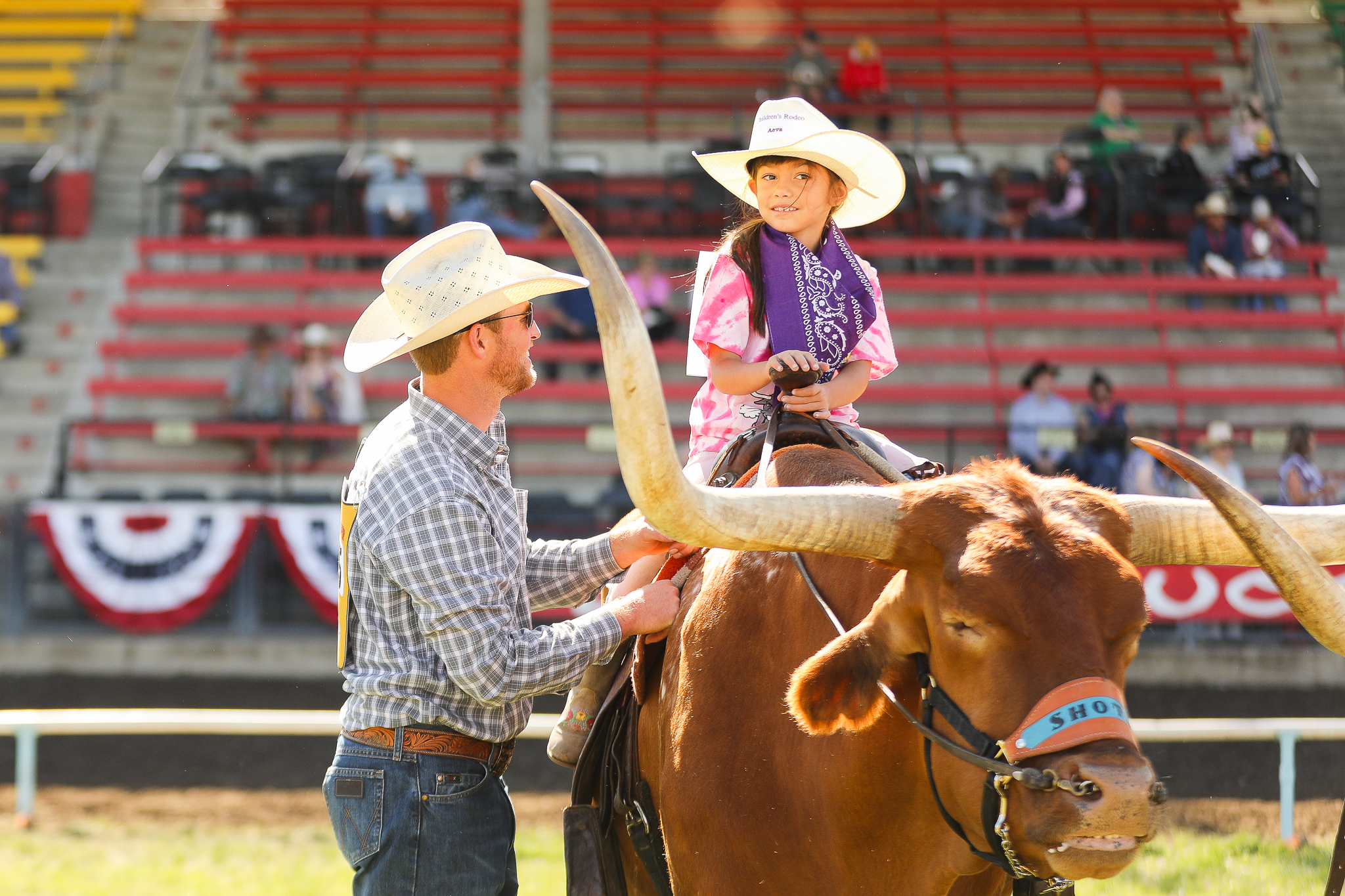 cowboy and girl on steer