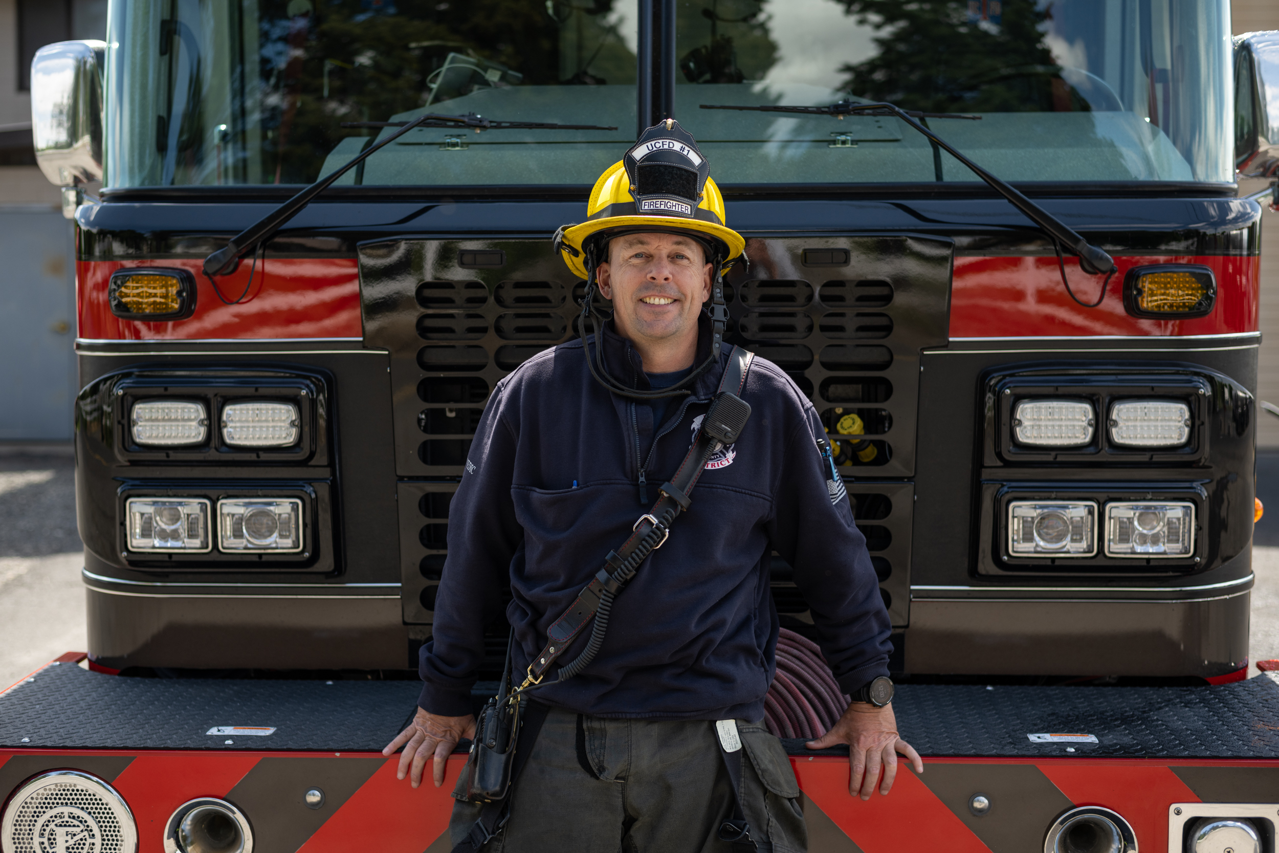 BMCC's Chris Wrathall stands in front of a fire truck to promote EMS program