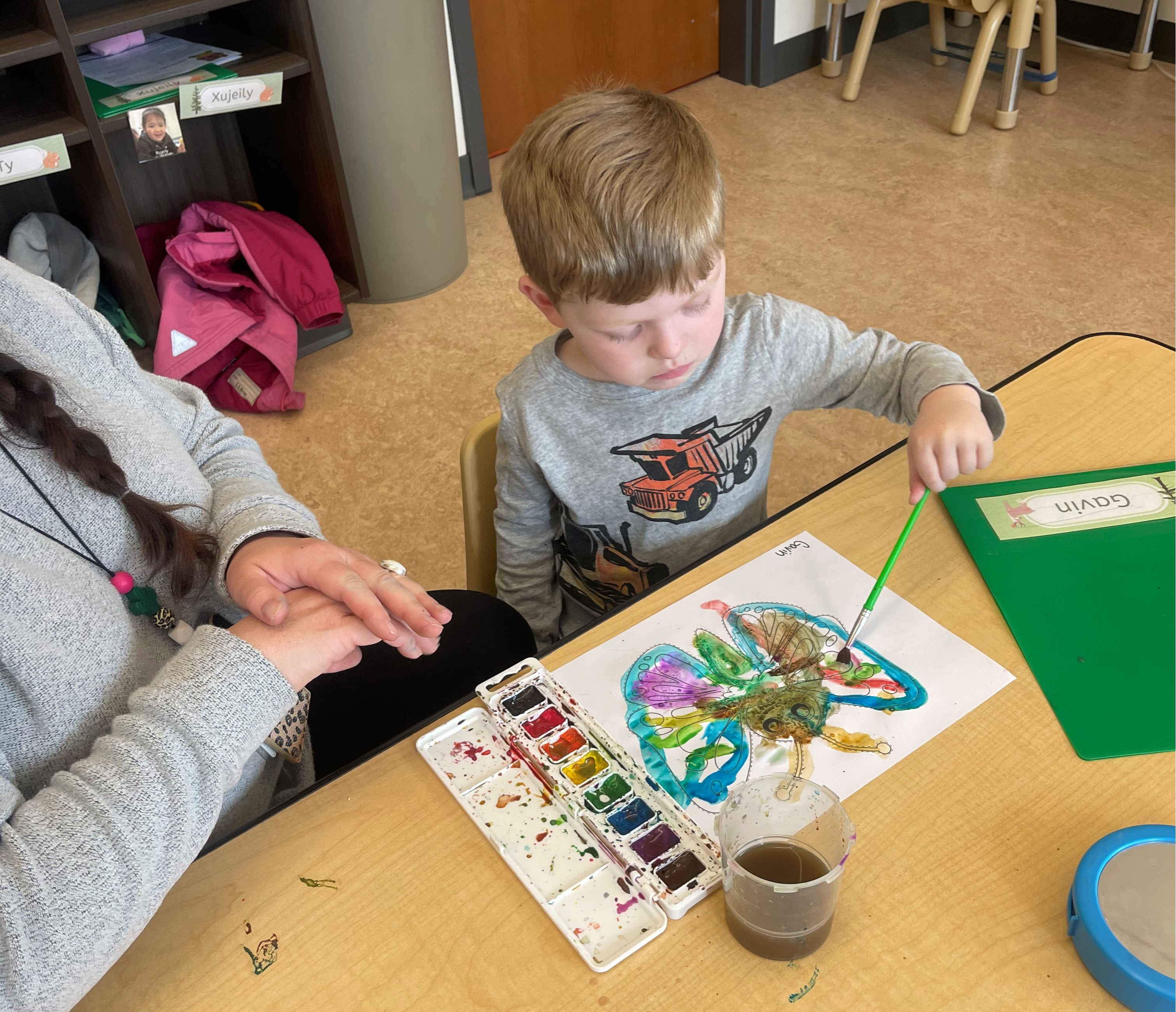 A photo of a teacher playing with some students.