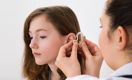 teen with hearing aid